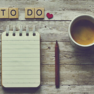 To-Do List on desk with coffee.